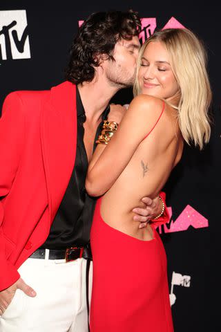 <p>Kevin Mazur/Getty</p> Chase Stokes and Kelsea Ballerini shares a sweet moment at the 2023 MTV VMAs on Sept. 12