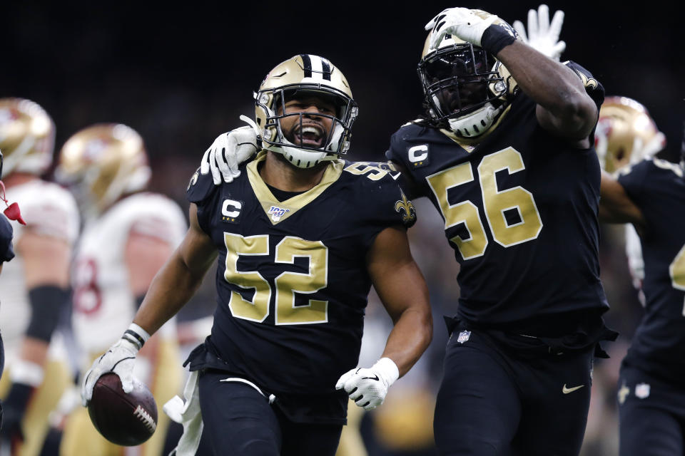 New Orleans Saints linebacker Craig Robertson (52) celebrates his interception with outside linebacker Demario Davis (56) in the second half an NFL football game against the San Francisco 49ers in New Orleans, Sunday, Dec. 8, 2019. (AP Photo/Brett Duke)