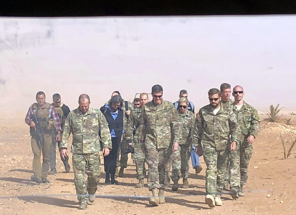 In this image made through a vehicle window, U.S. Gen. Joseph Votel, the top U.S. commander in the Middle East, center, arrives for an unannounced visit Monday, Oct. 22, 2018, at the al-Tanf military outpost in southern Syria. The U.S. trains Syrian opposition at the garrison outpost. (AP Photo/lolita Baldor)