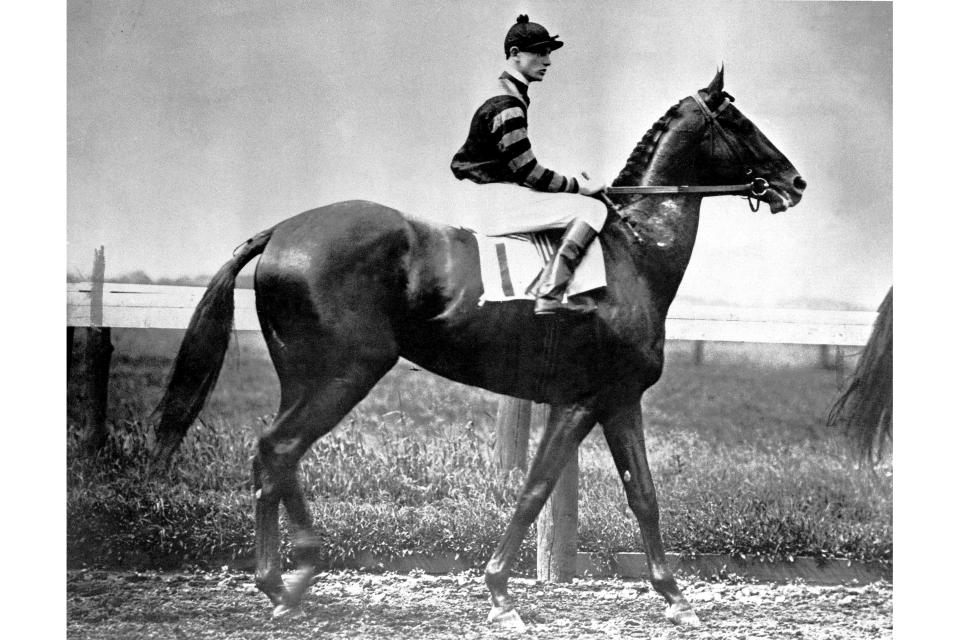 Jockey Clarence Kummer rides Man O'War to the starting line for the 1920 Dwyer race at New York's Aqueduct Race Track, July 10, 1920. Horses like Seabiscuit, Man O’War and Secretariat were well known in their time beyond racing circles, pop culture icons fed in part by radio, newspapers and, eventually, TV. (AP Photo)