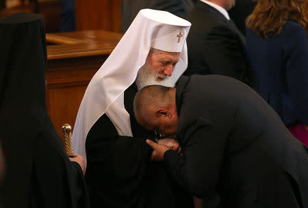 Bulgaria's new Prime Minister Boiko Borisov kisses the hand of Bulgarian Patriarch Neofit after a swearing-in ceremony in the parliament in Sofia, Bulgaria,May 4, 2017. REUTERS/Stoyan Nenov