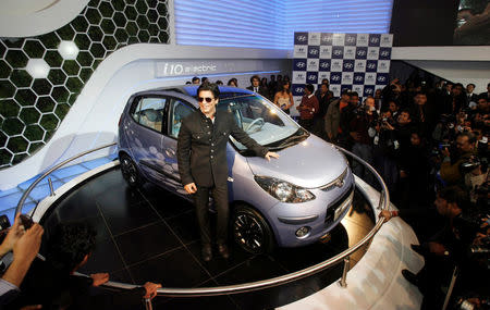 FILE PHOTO: Bollywood actor Shah Rukh Khan poses with Hyundai's "i 10 electric" car at India's Auto Expo in New Delhi January 6, 2010. REUTERS/Adnan Abidi/File Photo