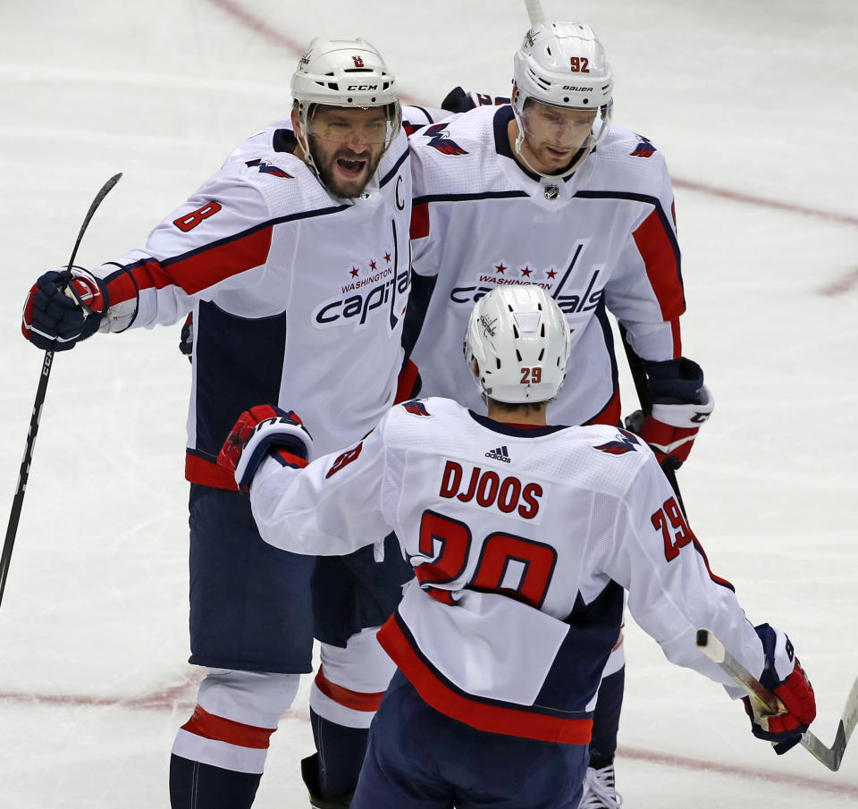 Washington Capitals' Alex Ovechkin (8) celebrates his goal with Evgeny Kuznetsov (92) and Christian Djoos (29) during the first period of an NHL hockey game against the Pittsburgh Penguins in Pittsburgh, Thursday, Oct. 4, 2018. (AP Photo/Gene J. Puskar)