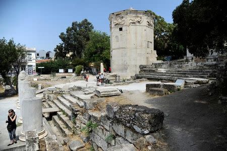 Tourists visit the Tower of the Winds, open to the public for the first time in more than 200 years after being restored, in the Roman Agora, in Plaka, central Athens, Greece, August 23, 2016. Picture taken August 23, 2016. REUTERS/Michalis Karagiannis