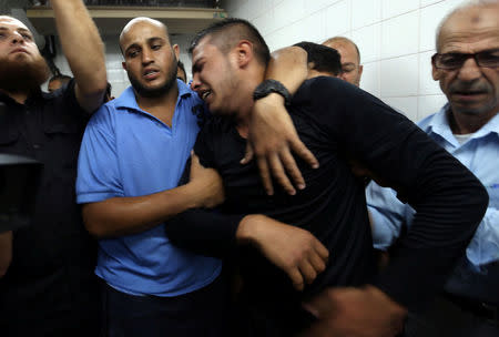 A relative of a Palestinian Islamic Jihad militant, who was killed in an Israeli tank shelling that targeted an observation post, reacts at a hospital in the southern Gaza Strip May 27, 2018. REUTERS/Ibraheem Abu Mustafa