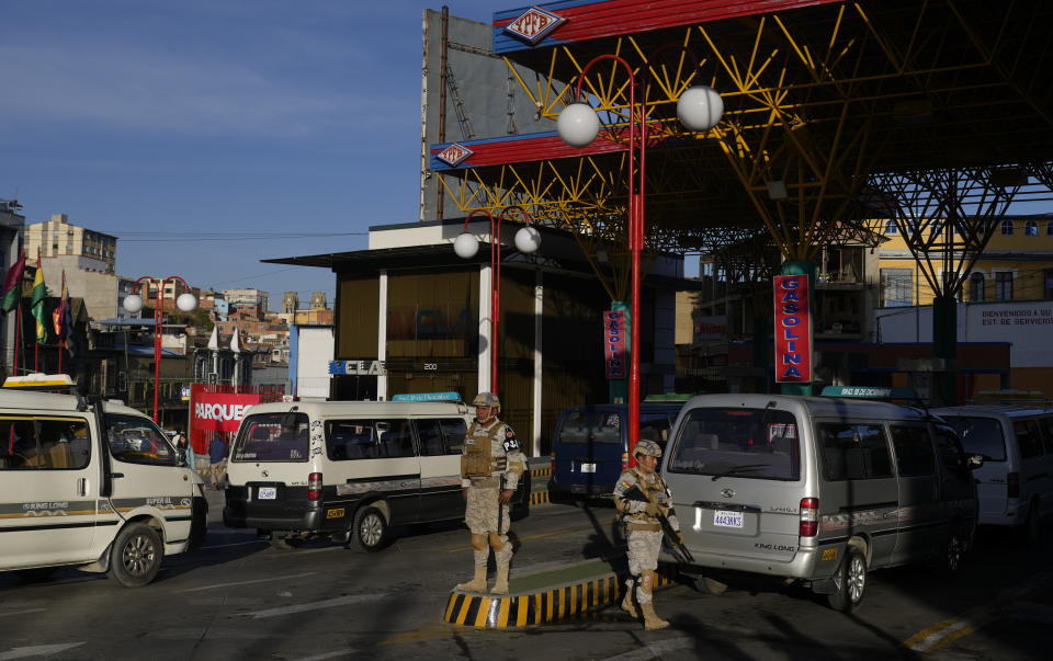 FILE - Soldiers stand guard at a gas station following a government order for the military to monitor gas stations and borders to prevent the illegal departure of fuel and food, in La Paz, Bolivia, June 12, 2024. (AP Photo/Juan Karita, File)