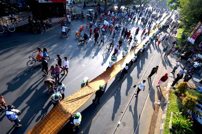 Longest batik: The 4,100-meter long batik fabric was spread from Purwosari train station to Gladag Square on the city's main street of Jl Slamet Riyadi for two hours during a car free day. (