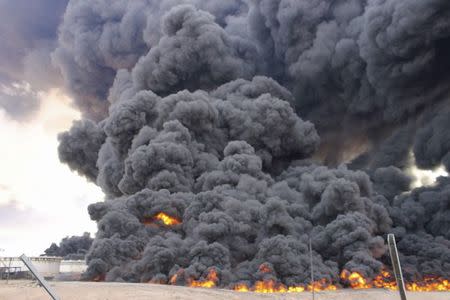 Smoke rises from a fire from an oil tank at the port of Ras Lanuf, Libya January 22, 2016. REUTERS/Stringer