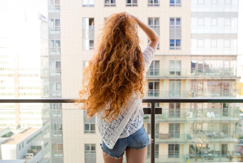 A redheaded model named Beatta from Warsaw, Poland, looking out of a window