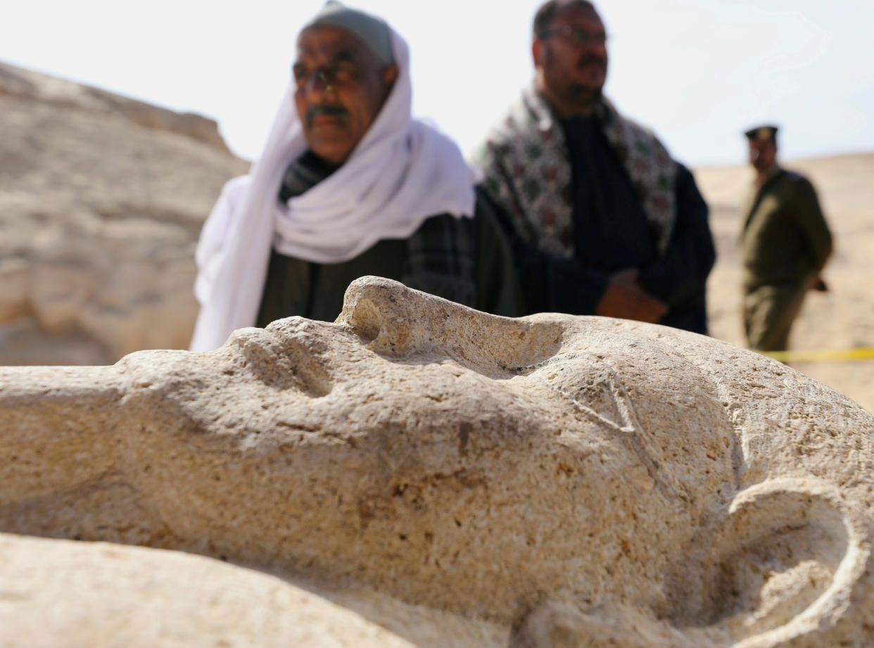 Men secure a stone sarcophagus discovered in an ancient burial site in Minya, Egypt February 24, 2018. REUTERS/Mohamed Abd El Ghany