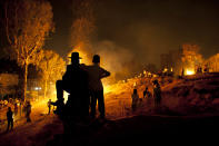 <p>Ultra-Orthodox Jews stand next to bonfires during Lag Ba’Omer celebrations to commemorate the end of a plague said to have decimated Jews in Roman times, in Bnei Brak, Israel, May 9, 2012. (Photo: Oded Balilty/AP) </p>