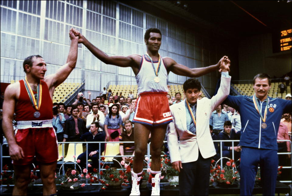 Cuban champion Teofilo Stevenson (C-gold medal) Soviet Pyotr Zaev (L-silver medal) and German Republic Democratic Jurgen Fanghanel (R- bronze medal) wawe on the podium of the Olympic heavyweight 81+ boxing event that won Teofilo Stevenson. Stevenson --who won 301 of the 321 fights he took part-- died of a heart attack at the age of 60 in Havana on June 11, 2012. AFP PHOTOSTAFF/AFP/GettyImages