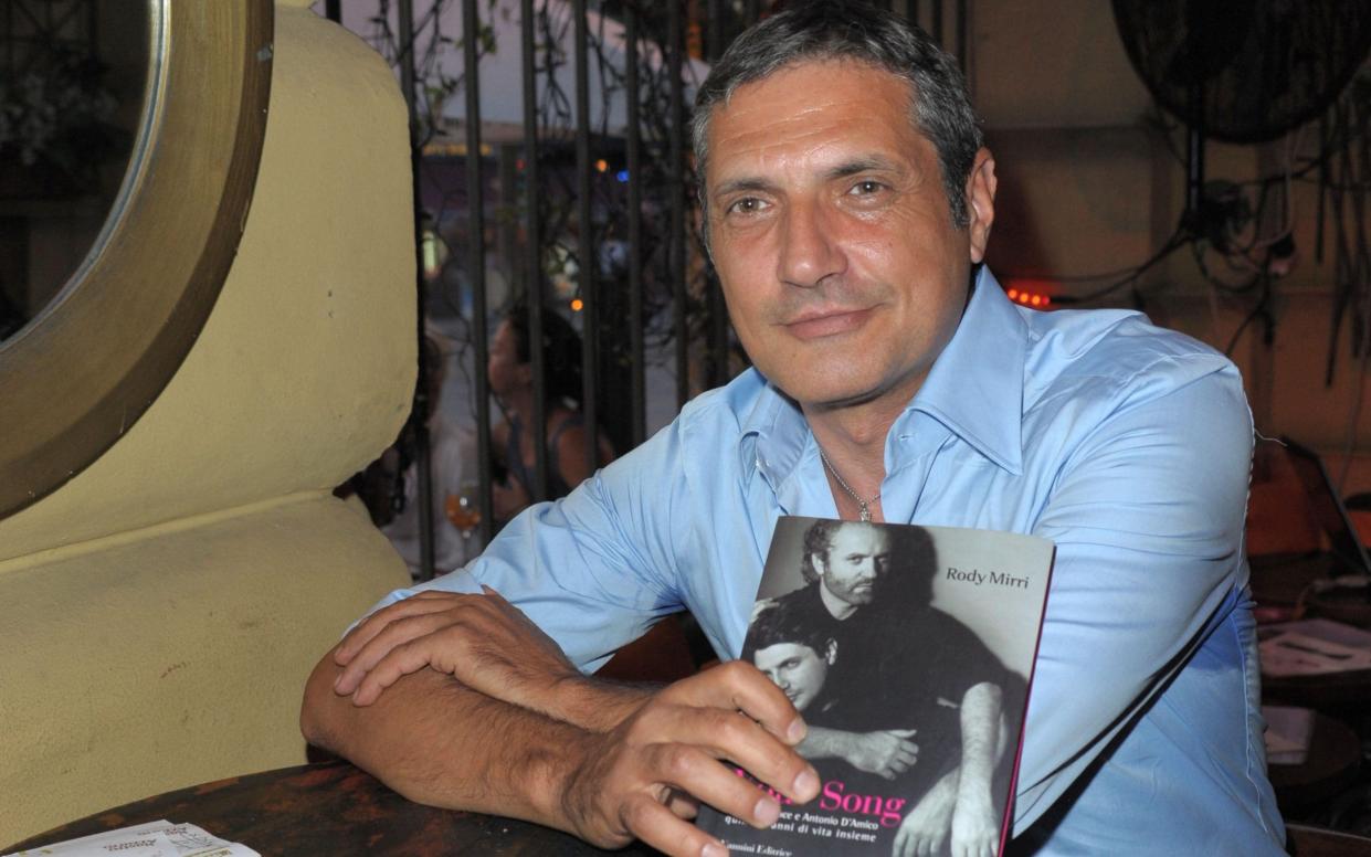 Antonio d'Amico in 2009 with a copy of the book It's Your Song, which told the story of his relationship with Gianni Versace - WEMM/Alamy