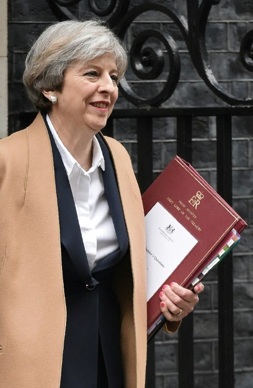 British Prime Minister Theresa May leaves 10 Downing Street before heading to the Houses of Parliament to attend the weekly Prime Minister's Questions (PMQs) in central London on March 29, 2017