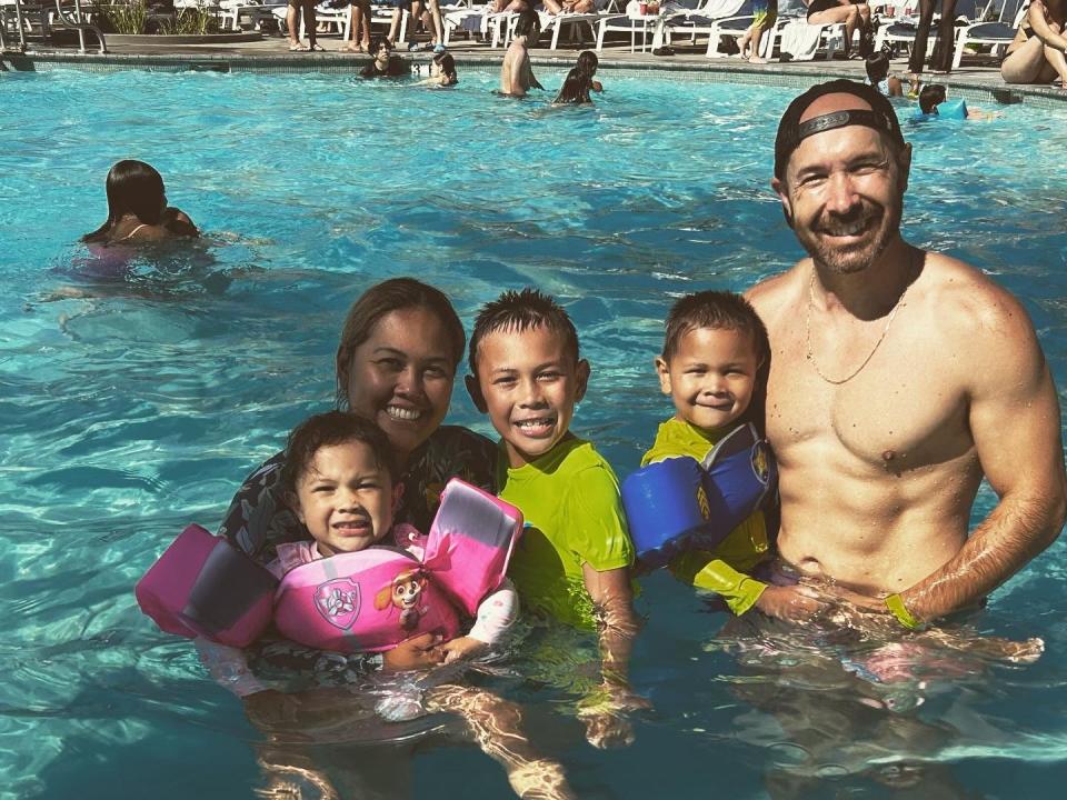 Ryan Peck and his family swimming in a pool.