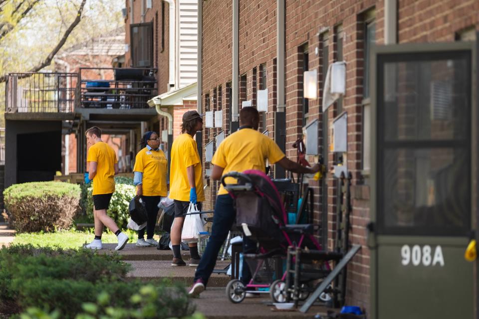 Volunteers going door-to-door to deliver groceries at a Walk of Love event, a hunger relief program run by Elijah's Heart.