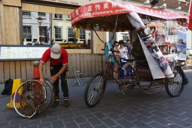 57-year-old Chinese farmer Chen Guanming, who cycled from China to London — AFP photo