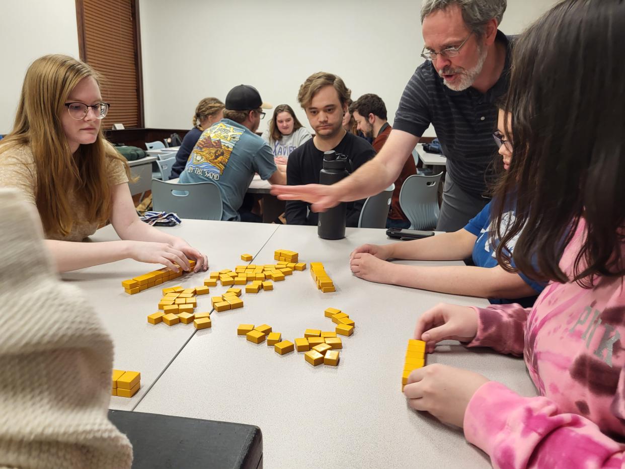 FHU professor of English Dr. John McLaughlin explains the objective of the game mahjong, which is played by the characters in Amy Tan's "The Joy Luck Club." In the story, the game keeps the Chinese immigrants connected to home and serves as a time for them to share their dreams and hopes.