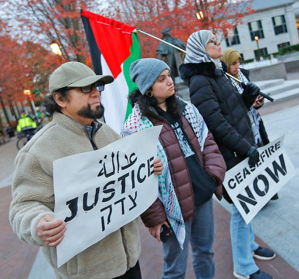 Ali, daughter Zee and wife Dina, a Palestinian family from North Quincy, join a group of protesters gathered in Quincy Center to support a ceasefire in Gaza on Wednesday Nov. 15, 2023.