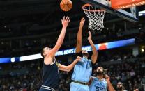 Dec 10, 2018; Denver, CO, USA; Denver Nuggets center Nikola Jokic (15) shoots over Memphis Grizzlies forward Kyle Anderson (1) and center Joakim Noah (55) in the second quarter at the Pepsi Center. Ron Chenoy-USA TODAY Sports