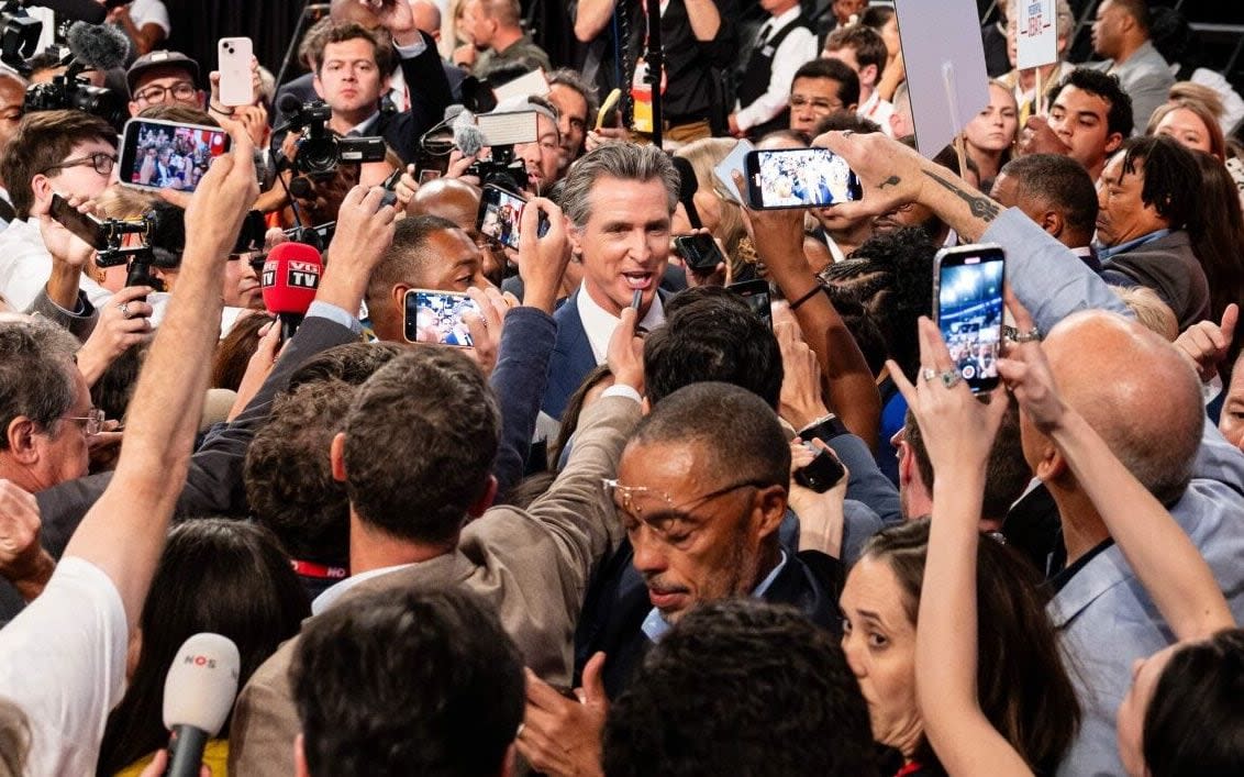 Gavin Newsom, governor of California (centre) speaks to members of the media following the first presidential debate in Atlanta