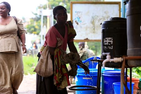 A woman washes her hands as she crosses the Mpondwe border which separates Uganda and the Democratic Republic of Congo before the ebola screening on the computerised Mpondwe Health Screening Facility in Mpondwe