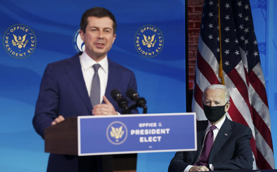 Former South Bend, Ind. Mayor Pete Buttigieg, President-elect Joe Biden's nominee to be transportation secretary, speaks as Biden looks on during a news conference at The Queen theater in Wilmington, Del., Wednesday, Dec. 16, 2020. (Kevin Lamarque/Pool via AP)