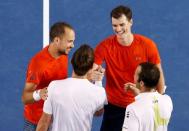 Britain's Jamie Murray (2nd R) and his partner Brazil's Bruno Soares (L) shake hands with Canada's Daniel Nestor and his partner Czech Republic's Radek Stepanek (R) after Murray and Soares won their doubles final match at the Australian Open tennis tournament at Melbourne Park, Australia, January 31, 2016. REUTERS/Jason Reed