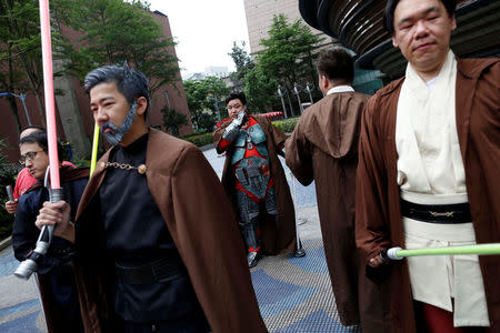 Fans dressed as the characters from "Star Wars" react during Star Wars Day in Taipei, Taiwan May 4, 2017. REUTERS/Tyrone Siu