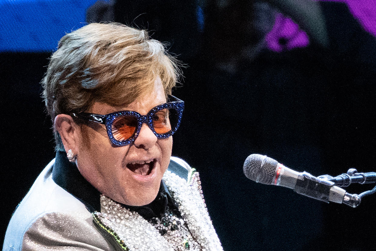 dpatop - 27 April 2023, Bavaria, Munich: Singer and pianist Elton John sits on stage at the Olympic Hall during a concert as part of his 