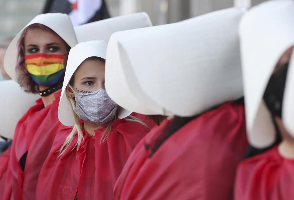 Protesters taking part in a rally against Polish government plans to withdraw from the Istanbul Convention on prevention and combatting of home violence, in Warsaw, Poland, on Friday, July 24, 2020. In the opinion of Poland's right-wing government the convention promotes "gender" ideologies alien to Poland's Catholic tradition.(AP Photo/Czarek Sokolowski)