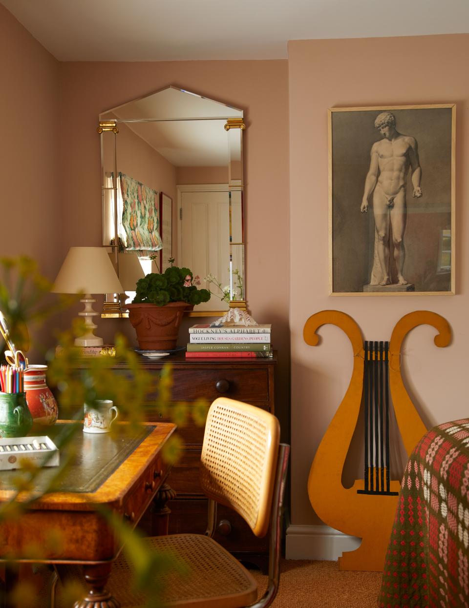 The lyres (one shown) in the pink bedroom once graced a fairground; victorian desk, Marcel Breuer chair.