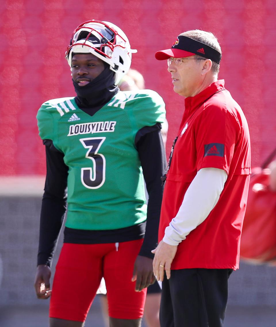 Malik Cunningham and coach Scott Satterfield chat during practice at Cardinal Stadium on Sunday, April 3, 2021