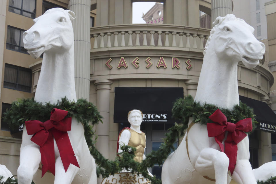 Holiday decorations adorn the sculptures outside Caesars casino in Atlantic City, N.J. on Dec. 28, 2023. Atlantic City faces challenges in the new year including a potential smoking ban in its nine casinos, and their quest to return to pre-pandemic business levels. (AP Photo/Wayne Parry)