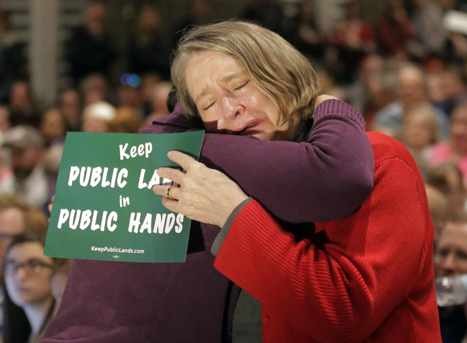 Pat Winmill, right, receives a hug after speaking to Republican U.S. Rep. Chris Stewart during his town hall meeting Friday, March 31, 2017, in Salt Lake City. Stewart says he knows that many of those attending his town hall in heavily Democratic Salt Lake City probably didn't vote for him, but the Republican congressman says he feels it's important to appear before his constituents. (AP Photo/Rick Bowmer)