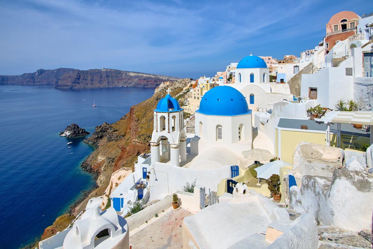 White houses with sky blue roofs in Santorini, Greece