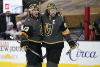 Vegas Golden Knights right wing Mark Stone, right, celebrates after defenseman Alec Martinez, left, scored a goal against St. Louis Blues during the second period of an NHL hockey game Friday, May 7, 2021, in Las Vegas. (AP Photo/John Locher)