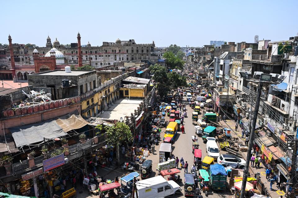 People make their way along a street in the old quarters of New Delhi on April 19, 2021, as India's capital will impose a week-long lockdown from tonight, officials said, while the megacity struggles to contain a huge surge in Covid-19 cases with hospitals running out of beds and oxygen supplies low. (Photo by Sajjad HUSSAIN / AFP) (Photo by SAJJAD HUSSAIN/AFP via Getty Images)