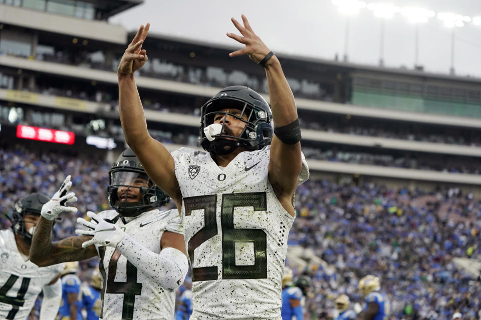 Oregon running back Travis Dye (26) celebrates after a rushing touchdown during the second half of an NCAA college football game against UCLA, Saturday, Oct. 23, 2021, in Pasadena, Calif. (AP Photo/Marcio Jose Sanchez)