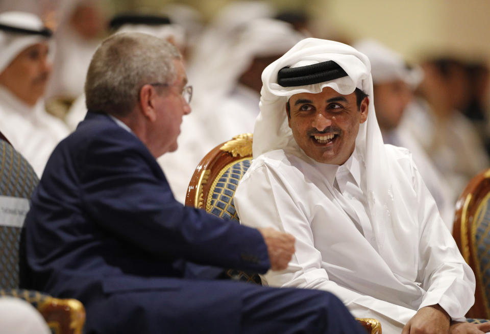 Emir of Qatar Sheikh Tamim bin Hamad Al Thani speaks to IOC President Thomas Bach ahead of the opening ceremony for the World Athletics Championships on the Corniche in Doha, Qatar, Friday, Sept. 27, 2019. (AP Photo/Hassan Ammar)