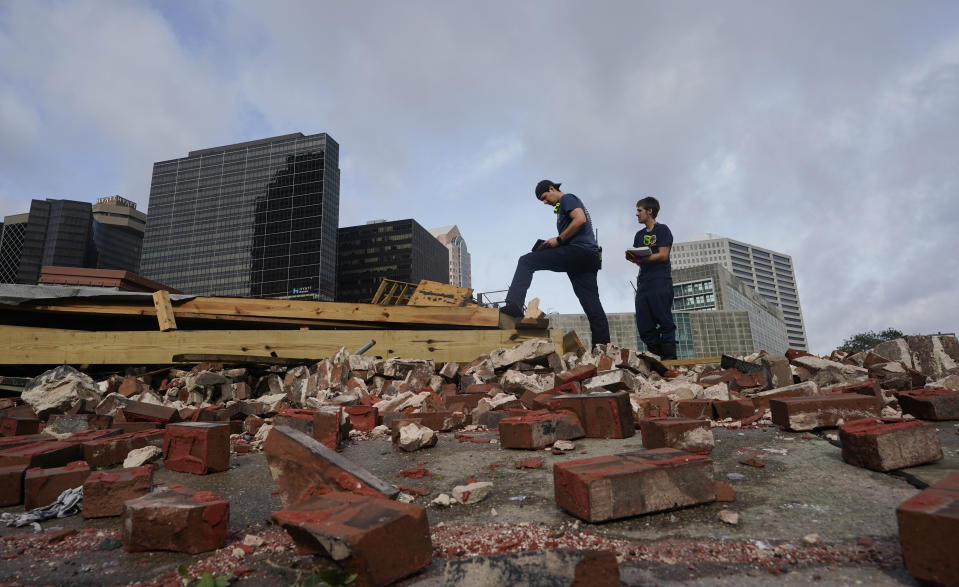 New Orleans Firefighters assess damage as they look through debris after a building collapsed from the effects of Hurricane Ida, Monday, Aug. 30, 2021, in New Orleans, La. All of New Orleans lost power right around sunset Sunday as the hurricane blew ashore on the 16th anniversary of Katrina, leading to an uneasy night of pouring rain and howling wind. The weather died down shortly before dawn. (AP Photo/Eric Gay)