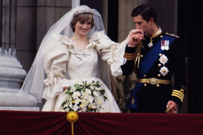 The Prince and Princess of Wales on the balcony of Buckingham Palace on their wedding day, 29th July 1981. Diana wears a wedding dress by David and Elizabeth Emmanuel and the Spencer family tiara. (Photo by Terry Fincher/Princess Diana Archive/Getty Images)