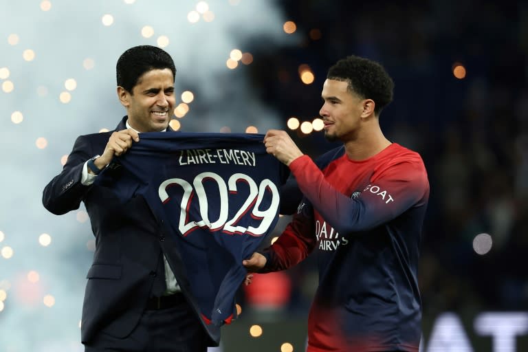 Paris Saint Germain's Qatari president Nasser al-Khelaifi (L) poses with Paris Saint-Germain's French midfielder #33 Warren Zaire-Emery during a ceremony marking the prolongation of the player's contract ahead of the French L1 football match between Paris Saint-Germain (PSG) and Le Havre AC at the Parc des Princes Stadium in Paris on April 27, 2024. (FRANCK FIFE)