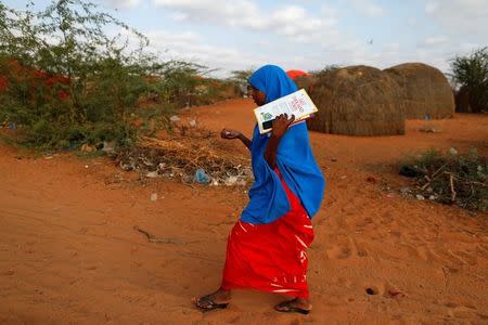 Zeinab, 14, walks to school at a camp for internally displaced people from drought hit areas in Dollow, Somalia April 3, 2017. REUTERS/Zohra Bensemra