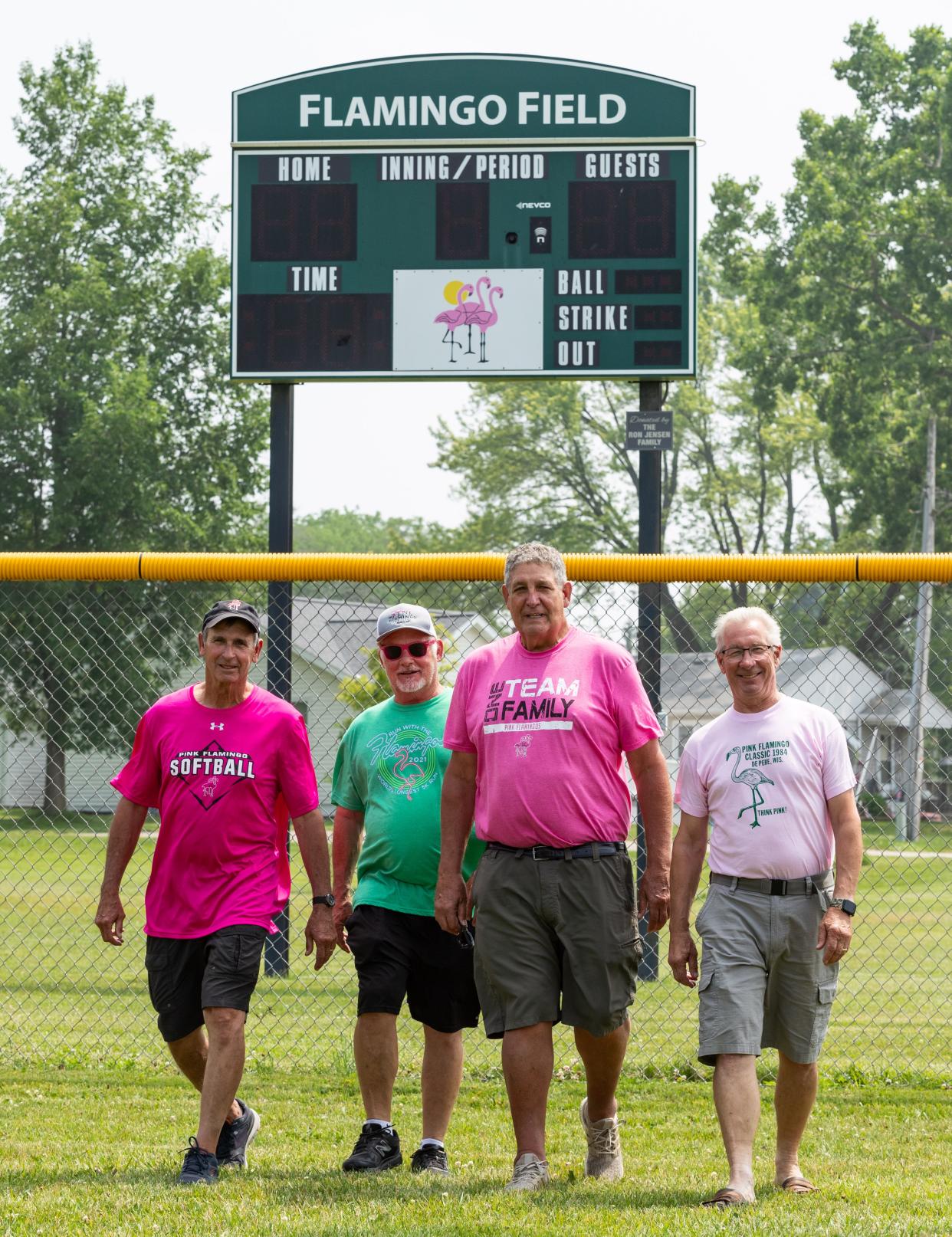 Bruce Willems, from left, David Vande Hei, Jerry Olmsted and Jeff Gorenc of the Pink Flamingos show their colors on Flamingo Field at Legion Park in De Pere. The four men have been with the softball tournament since it started in 1984. The festival turns 40 this weekend.