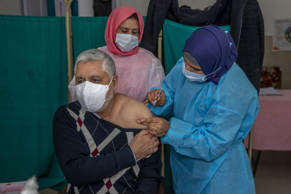 Shakeel Ahmed, a doctor, receives a shot of the Covishield vaccine at a primary health center in Srinagar, Indian controlled Kashmir, Tuesday, March 2, 2021. India is expanding its COVID-19 vaccination drive beyond health care and front-line workers, offering the shots to older people and those with medical conditions that put them at risk. (AP Photo/ Dar Yasin)