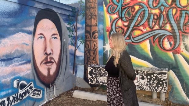 Demi Wilson looks at a portrait of her late brother Bronson. The mural was painted by  Red Deer artist Jesse Gouchey. 