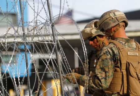 U.S. Marines set up a barricade with concertina wire, at the border between Mexico and the U.S., in preparation for the arrival of migrants, in Tijuana, Mexico, November 13, 2018. REUTERS/Jorge Duenes