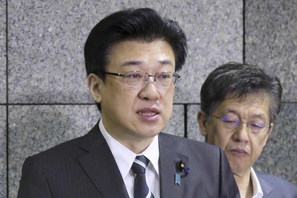 Japanese Defense Minister Minoru Kihara, left, speaks to reporters following a rocket launch by North Korea, at Defense Ministry in Tokyo Tuesday, May 28, 2024. A rocket launched by North Korea to deploy the country's second spy satellite exploded shortly after liftoff Monday, state media reported, in a setback for leader Kim Jong Un's hopes to field satellites to monitor the U.S. and South Korea. (Kyodo News via AP)