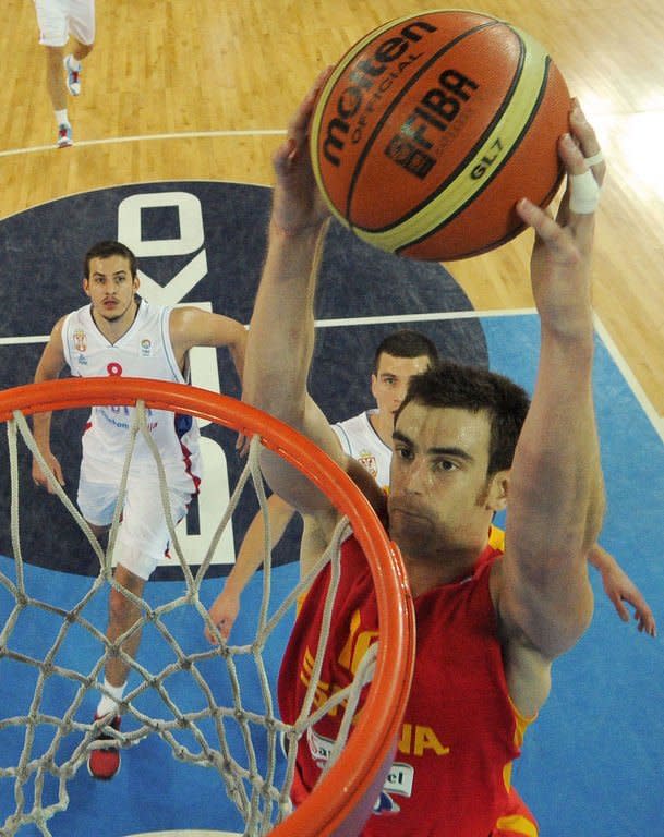 Victor Claver of Spain (R) dunks the ball during a FIBA European basketball championship quarter-final match between Serbia and Spain in Ljubljana, Slovenia, on September 18, 2013. Two-time reigning champions Spain eased past Serbia 90-60